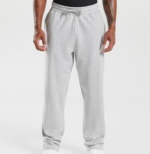 Pantalones de chándal de gran tamaño con logotipo personalizado Pantalones de chándal holgados de pierna ancha de alta calidad para hombres, pantalones básicos lisos de talla grande - Product Image 1