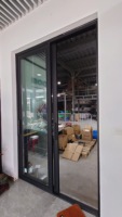 Porte coulissante en aluminium à double vitrage à 4 panneaux minimaliste Entrée avant de maison verte de luxe durable pour ferme