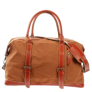 Sturdy canvas bag in cognac complemented by robust buffalo leather featuring adjustable shoulder strap for added convenience.