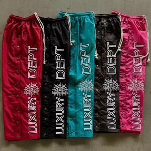 Pantalones de chándal OEM personalizados para mujer con botón a presión, cordón lateral, cintura, pierna ancha, pantalón acampanado de nailon - Product Image 1