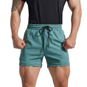 Pantalones cortos de entrenamiento de algodón 100% para hombre, pantalones deportivos de patrón sólido para gimnasio, pantalones deportivos con bolsillos en la cintura con cordón, pantalones cortos para correr al por mayor - Product Image 1