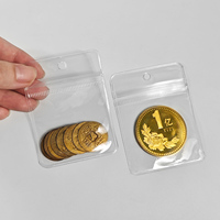 En stock : Pochette refermable en PVC transparente anti-oxydation avec trou de suspension et fermeture éclair pour l'emballage de pièces de monnaie, badges, pendentifs, breloques et bijoux