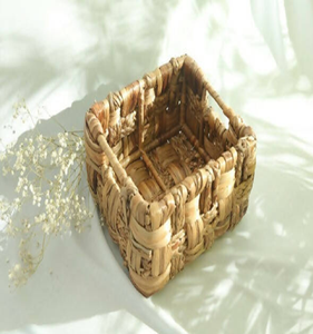 It's a structured <b>bag</b> with a wide, tapered body made from a tightly woven water hyacinth - Product Image 6