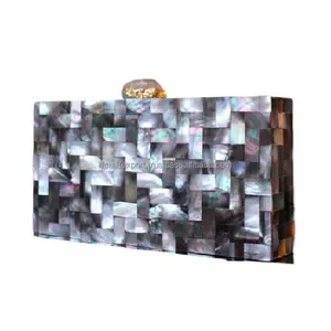 New Modern Featuring clutch in mother of pearl base with embedded rhinestones It has a gold chain from India by RF Crafts