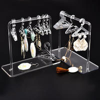 Support à boucles d'oreilles élégant et moderne en acrylique transparent, design étanche, taille personnalisable, pour organiser et présenter les boucles d'oreilles en magasin.