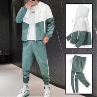 Ensemble survêtement deux pièces en polyester avec veste coupe-vent zippée en nylon et pantalon de jogging patchwork, collection hiver 2026