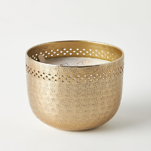 Un bougeoir cylindrique aux tons dorés avec une finition martelée texturée et un design perforé autour du bord supérieur. - Product Image 1