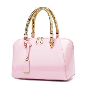 Bolsos de moda 2026 nuevos con asa tejida y cierre de cremallera, bolsos de mano de lujo para mujer, carteras de piel sintética patentada con colgante - Product Image 1