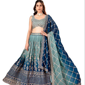 Este exquisito lehenga choli de tela georgette con motivos delicadamente cosidos a mano, patrones de micro lentejuelas, ideal para novias. - Product Image 1