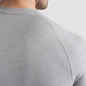 เสื้อกีฬา GA Sporty Slim Fit Compression ผ้าโพลีเอสเตอร์ถัก 100% สีเงินเทา สวมใส่สบาย ระบายอากาศได้ดี น้ำหนัก 180 กรัม มีโลโก้ - Product Image 6