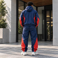 Ensemble survêtement homme personnalisé OEM, veste coupe-vent et pantalon de sport imperméables en polyester et nylon imprimé réfléchissant pour activités de plein air