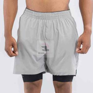 Pantalones cortos deportivos de doble capa con logotipo personalizado unisex con patrón sólido de cintura elástica y decoración informal de encaje - Product Image 5