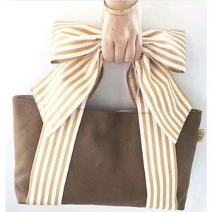 Sac fourre-tout en toile beige à rayures avec un grand nœud décoratif en beige et crème, conçu pour le transport quotidien à l'épaule - Product Image 1