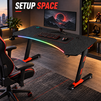 Bureau de jeu moderne noir avec plateau nervuré incurvé et pieds orange pour bureaux à domicile, salles d'étude et salles de jeu