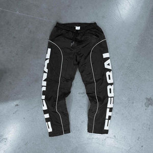 กางเกงวอร์มลำลองสำหรับผู้ชายกางเกงกันลมผ้าไนลอนสีพื้นกางเกงทรงตรงน้ำหนักเบามีกระเป๋า - Product Image 1