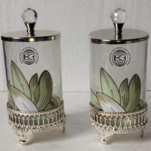 decorative <b>glass</b> <b>canister</b> with a silver base and lid. - Product Image 1