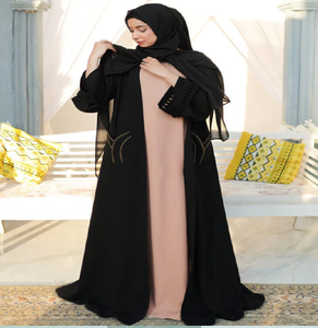 Sophisticated black open abaya over a peach inner <b>dress</b>. Timeless fashion available at wholesale prices. - Product Image 1