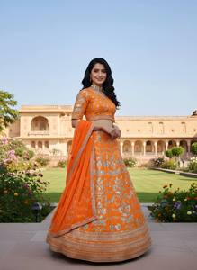 Resplandor en cada giro, esta vibrante lehenga naranja con intrincados bordados plateados es pura elegancia festiva. - Product Image 6