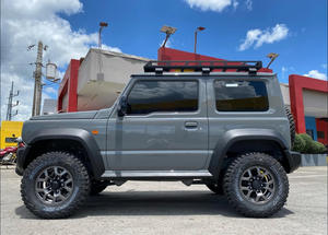 Nouvelle Suzuki Jimny à vendre! Véhicule tout-terrain gris 4x4 avec barres de toit et pneus tout-terrain améliorés - Product Image 2