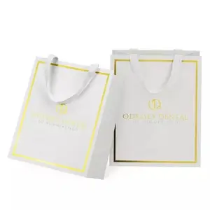 Custom Made Printed Logo Jewelry Packaging Paper Bag Shopping Paper Bag With Ribbon Handles Gold Foil White Gift Paper Bag