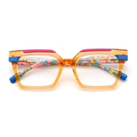 Lunettes en acétate multi-tons à monture carrée avec barre supérieure contrastante et embouts de branches au design unique
