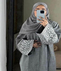 Abaya gris texturizada con delicado bordado floral blanco en las mangas anchas. Disponible a precios de mayoreo. - Product Image 1