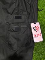 Pantalones de esquí cargo holgados unisex de alta calidad OEM, transpirables, ligeros, impermeables, 100% poliéster, de pierna ancha y extragrandes.