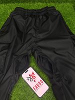 Pantalones de esquí cargo holgados unisex de alta calidad OEM, transpirables, ligeros, impermeables, 100% poliéster, de pierna ancha y extragrandes.