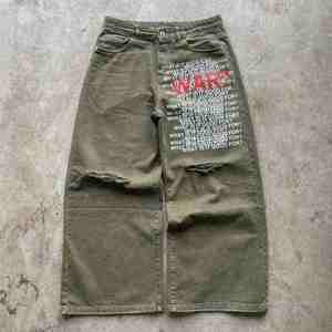 กางเกงยีนส์เอวสูงทรงแบ็กกี้ สไตล์วินเทจฟอกสี ขาดๆ แต่งกระดุม ทรงขาบาน สตรีทแวร์ฮิปฮอป - Product Image 1