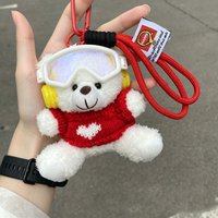Peluches d'hiver en gros : ours en peluche avec lunettes de ski, pulls à motif cœur, écouteurs, mini-ours en peluche porte-clés