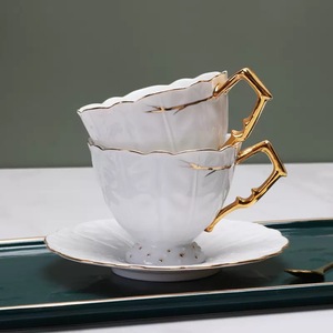 European High Quality Embossed Leaf Pattern Bone <b>China</b> Coffee <b>Cup</b> and Saucer Set featuring gold rim and handle - Product Image 4