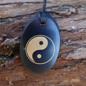 Colgante ovalado pulido de Shungita con serigrafía Ying Yang 1.3*2 pulgadas (34*50 mm) - Product Image 3