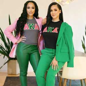 Camiseta con gráfico XAKA para mujer, cuello redondo, Manga corta en negro y gris con letras rojas y verdes en negrita, ropa griega, camiseta de hermandad - Product Image 1