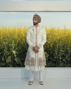 ÉBLOUISSANTE BRODERIE ZARI SUR SHERWANI BLANC, KURTA & PANTALON AVEC CHAUSSURE ASSORTIE AVEC PERLES DE VERRE EN CRISTAL EMBELLISHES, DABKA WORK @ 2024 - Product Image 1
