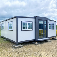 Maison conteneur modulaire pliable et extensible de 20 pieds, alimentée à l'énergie solaire, en panneaux sandwich d'acier ignifugés, avec bureau et salle de bain