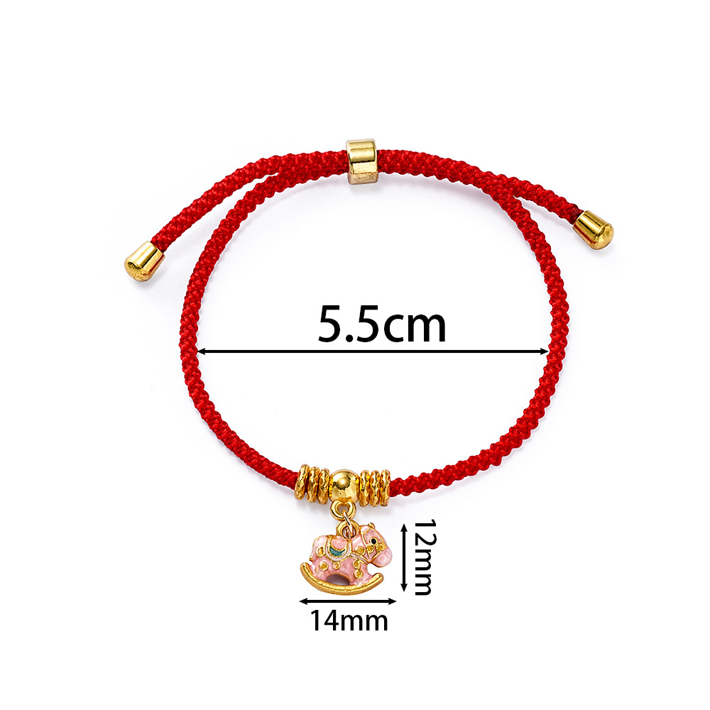Cheval à bascule rose avec perles dorées