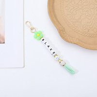 Nouveau Porte-clés en silicone style japonais-coréen transfrontalier, motif fleur, avec perles lettres DIY et pompon, ornement pendentif pour voiture et sac, modèle Chine