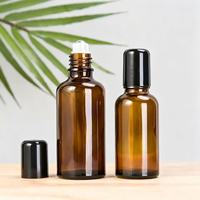 Bouteilles à bille en verre ambré de haute qualité avec boîtier noir et bille en acier inoxydable pour huiles essentielles