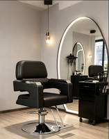 Chaise de salon professionnelle pour coiffeur, en cuir PU noir de luxe, avec repose-pieds en métal et accoudoirs réglables hydrauliquement.