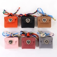 Nouveau mini sac à main porte-monnaie porte-clés en cuir avec cordon noué et breloque, disponible en différentes couleurs