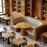 Ensemble de mobilier de restaurant moderne et luxueux aux tons chauds, tables rondes en bois massif et banquettes en cuir gris pour café