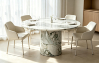 Table à manger élégante et minimaliste en marbre Arabescato à plateau rond et piétement unique, idéale pour les maisons modernes à plan ouvert