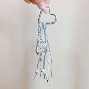 Breloque de sac à main en métal argenté pour téléphone portable, avec sangle en cuir PU et pompon, pour femmes - Product Image 2