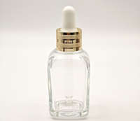 Flacon compte-gouttes carré en verre ambré vide de 10 ml avec anneau doré et bulbe en caoutchouc noir, pour huiles essentielles et cosmétiques, opaque, vente en gros