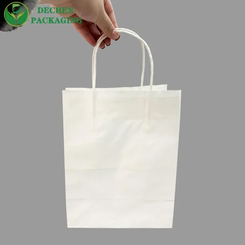 Bolsas de papel pequeñas con manijas para la tienda