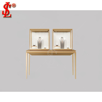 Comptoir de caisse de boutique de détail moderne en acier inoxydable doré, personnalisable, écologique, avec vitrine LED en verre pour présentation de bijoux