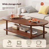 Table basse moderne minimaliste pour petits appartements et unités locatives ; pieds en bois massif, design discret, rangement à deux niveaux, forme ovale
