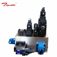 Bloc de commande auxiliaire bleu avec bouton rouge, vanne réglable sur ensemble de vannes hydrauliques empilées