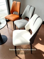Chaise de salle à manger en cuir au design minimaliste moderne de style nordique avec dossier creux, disponible en orange, gris clair et blanc
