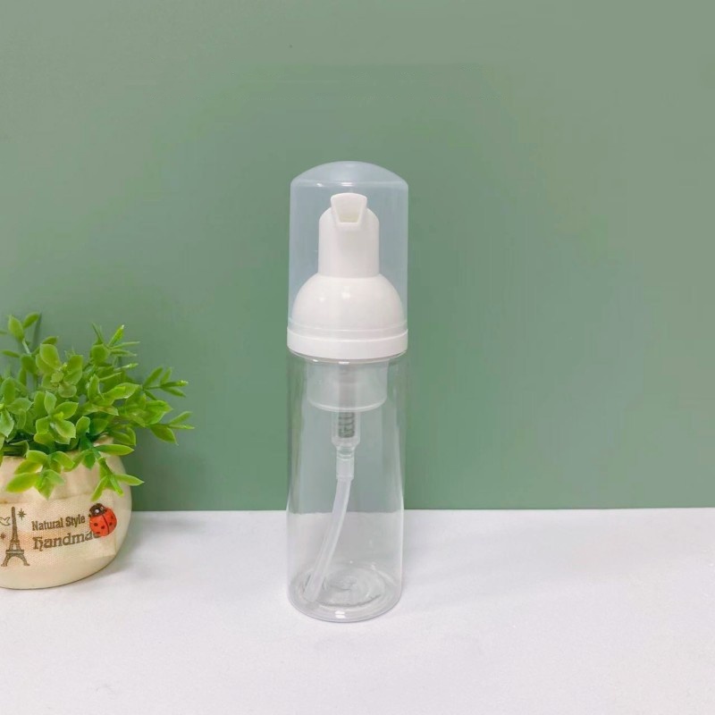 Flacon transparent avec tête de pompe blanche et bouchon transparent